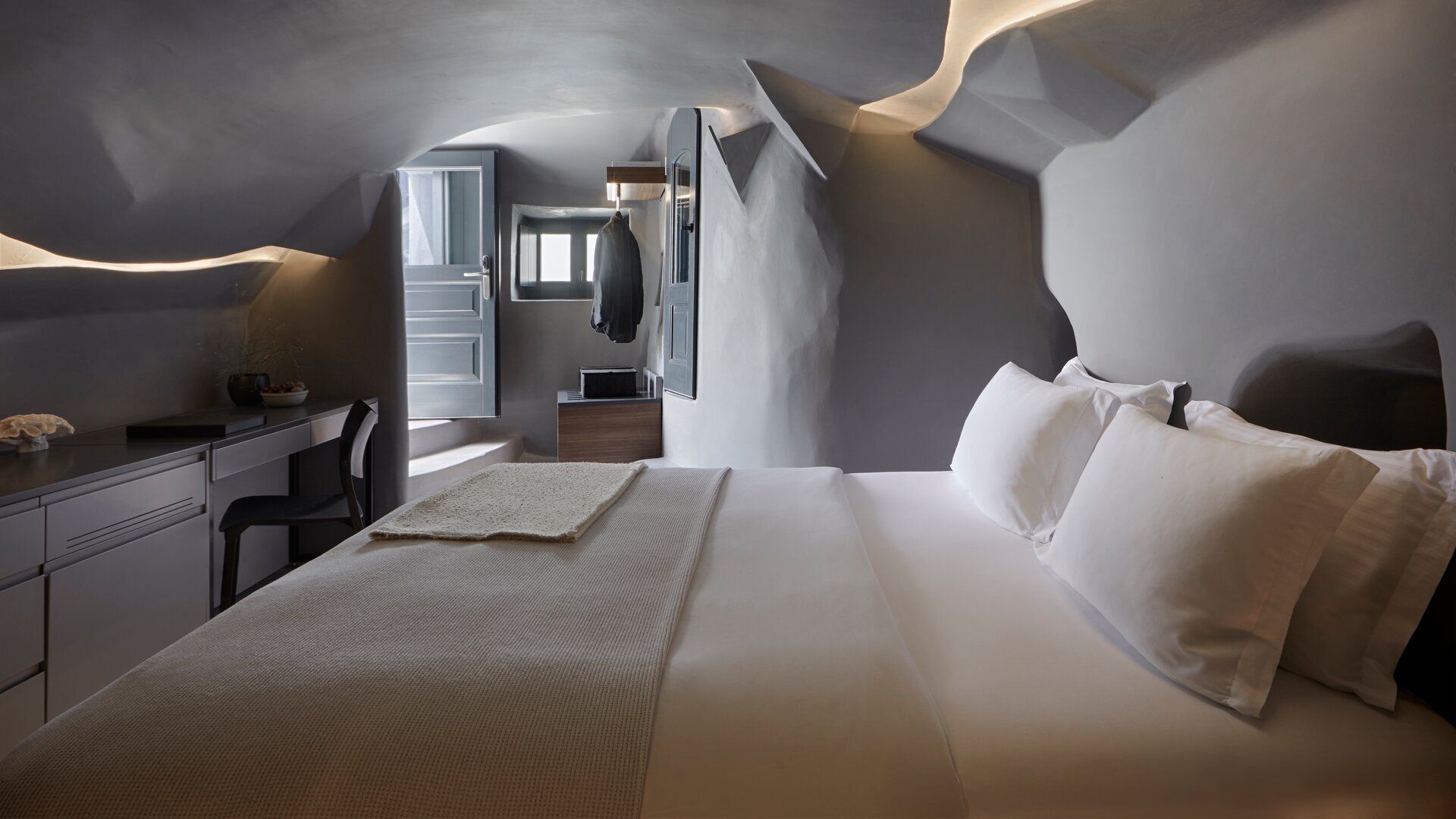 Junior Suite Sunset View with Heated Cave Pool | Bed Area
