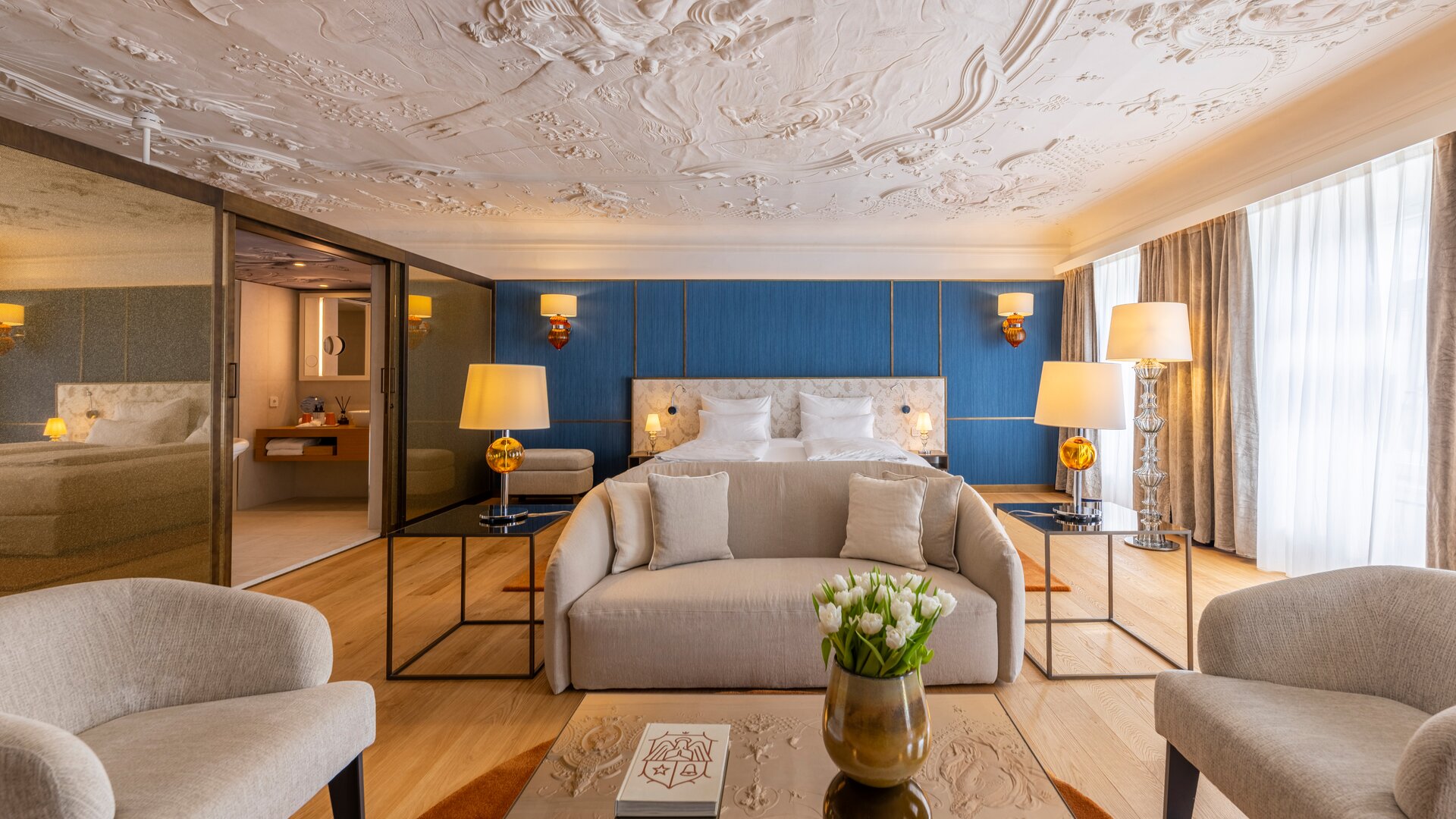 Honeymoon Suite Portrait View with Living Area in the Forefront and Bed in the Background