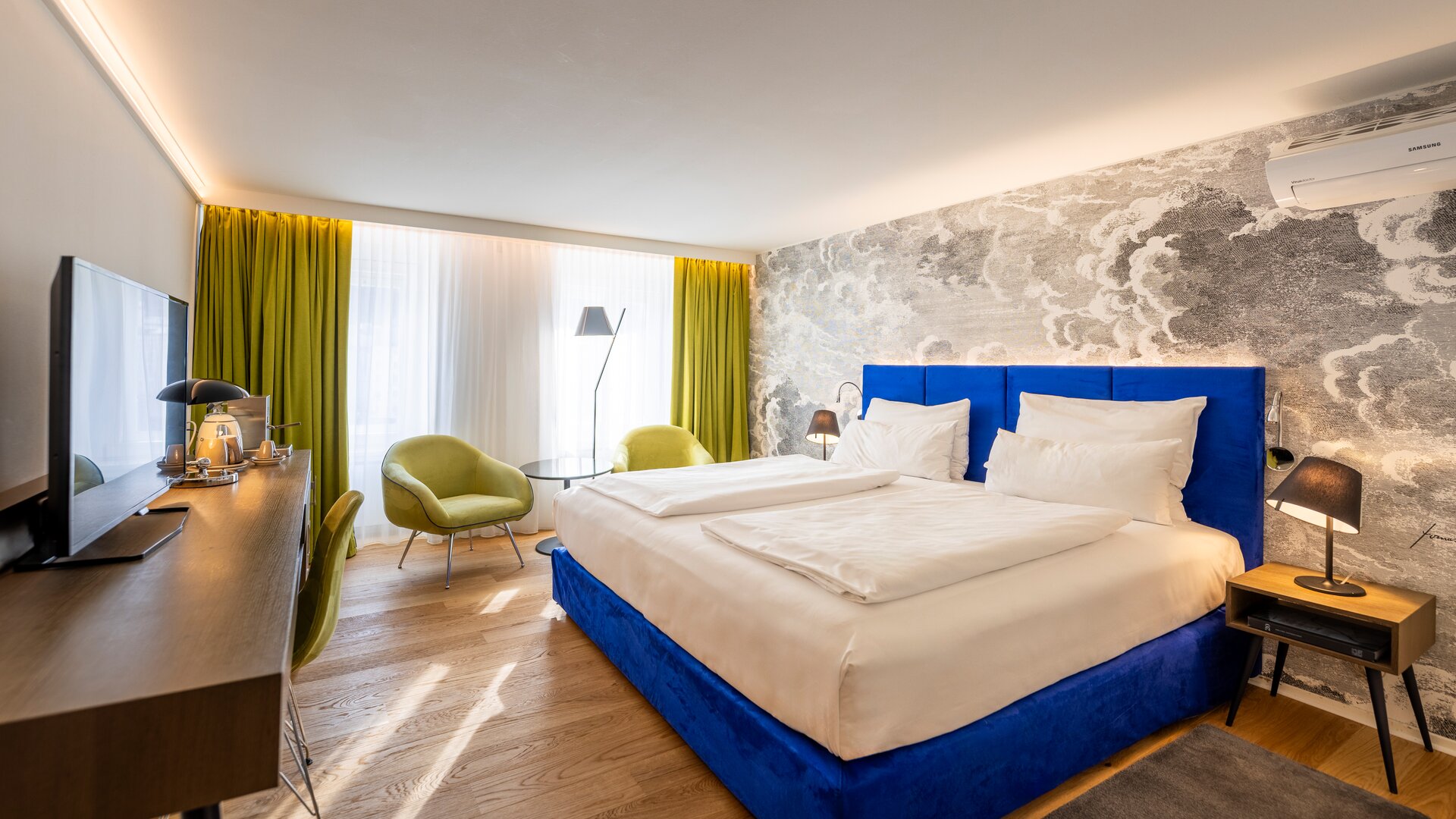Standard Guestroom with Blue and Green Décor Accents, and an Accent Wall of Black & White Patterned Wallpaper