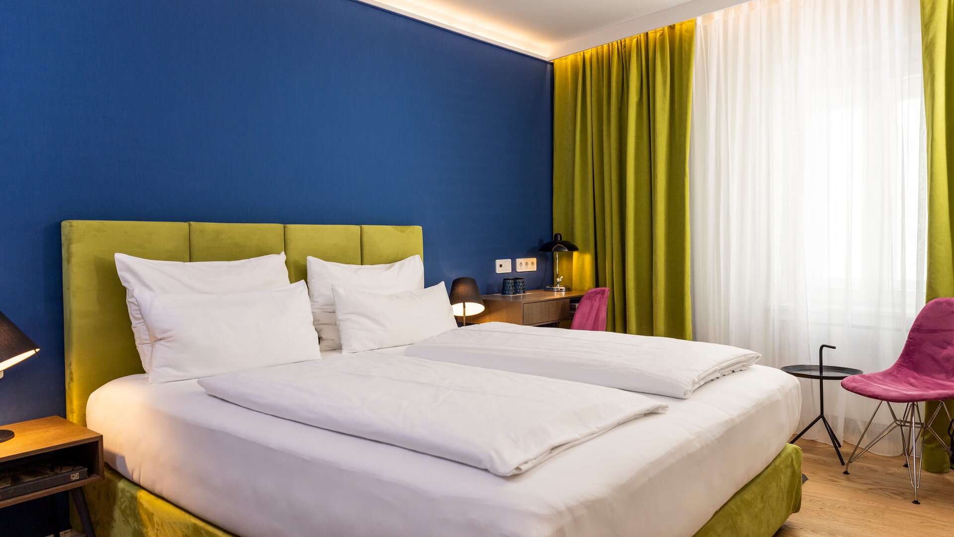 Standard Guestroom with Blue, Green and Pink Décor Accents, and a Blue Accent Wall