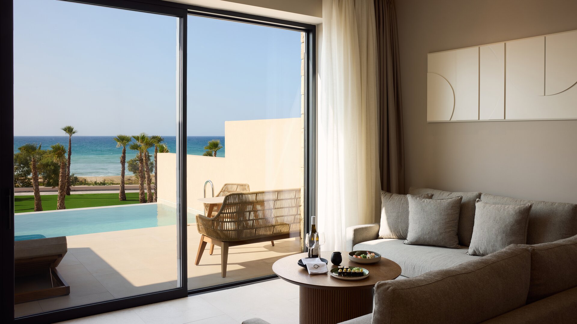 Premier Junior Suite Seating Space with View to Private Terrace and Pool
