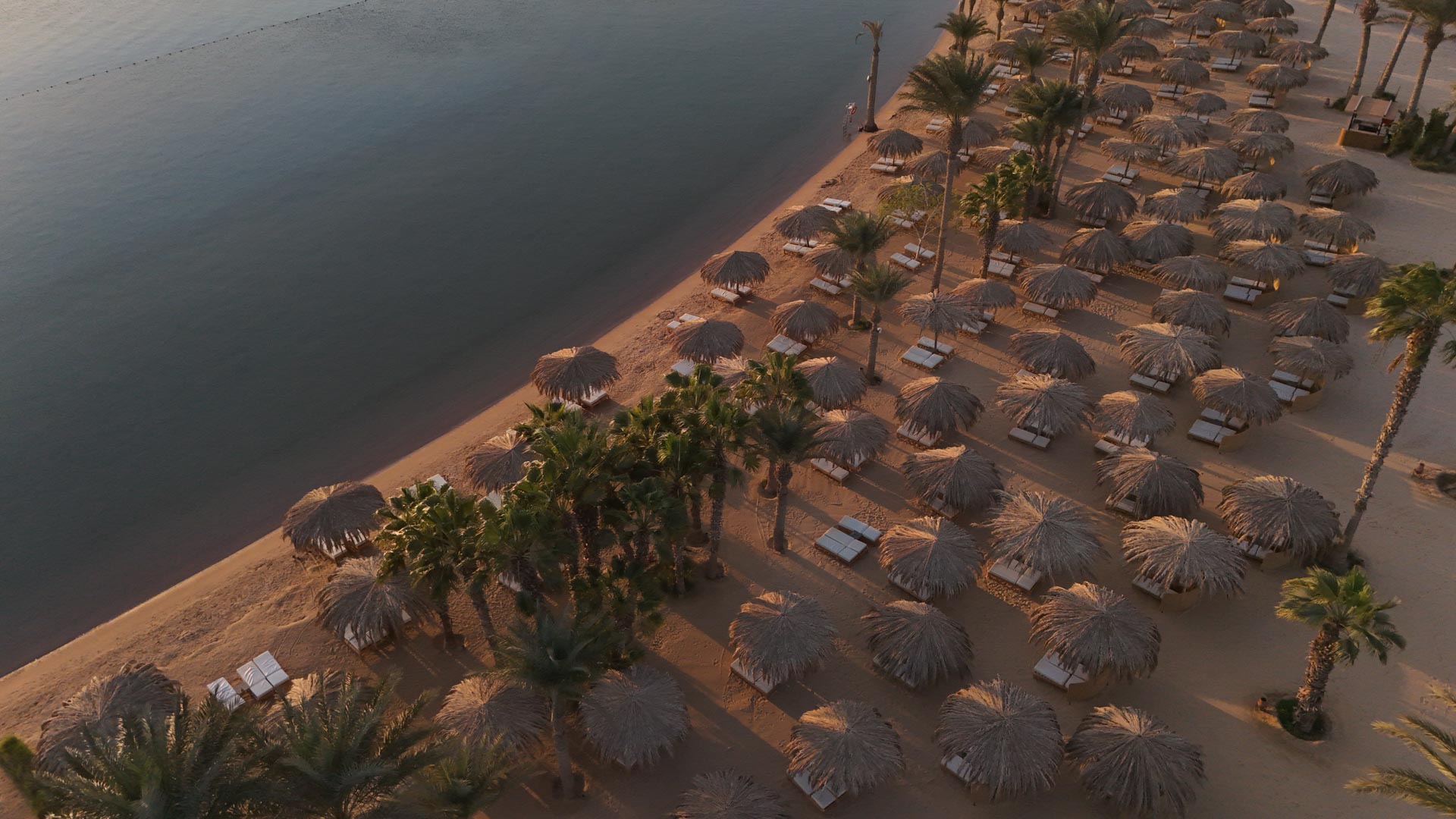 Beach with loungers and Tiki umbrellas