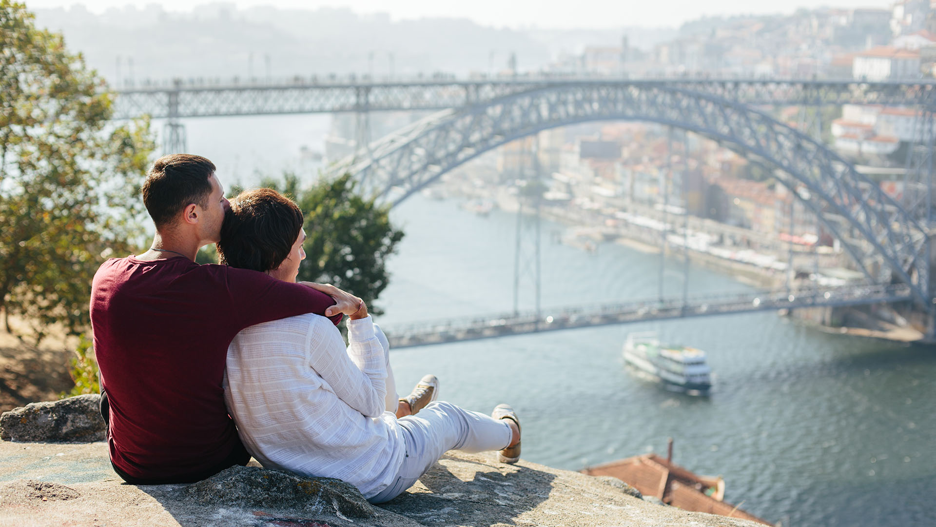 gay couple in front of bridge during vacation