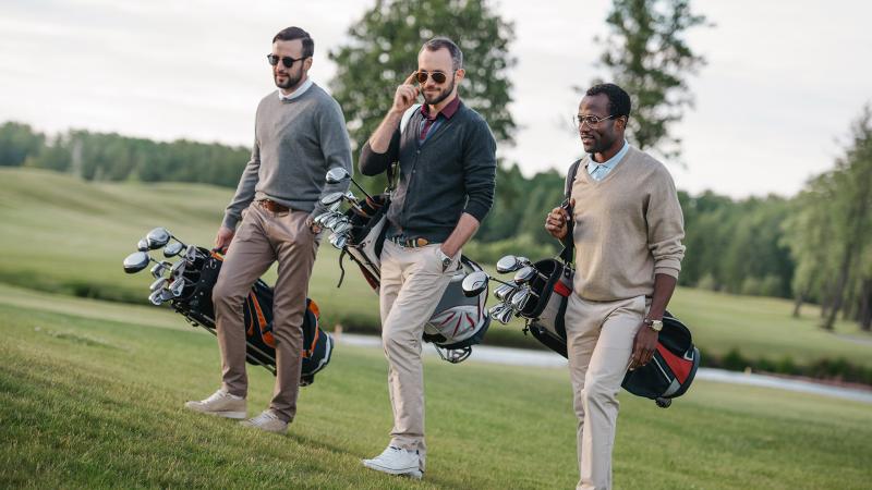 Group carrying golf bags