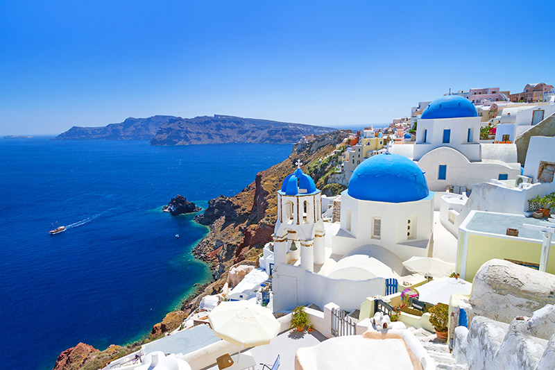 Beautiful blue waters surround Santorini, image from Shutterstock