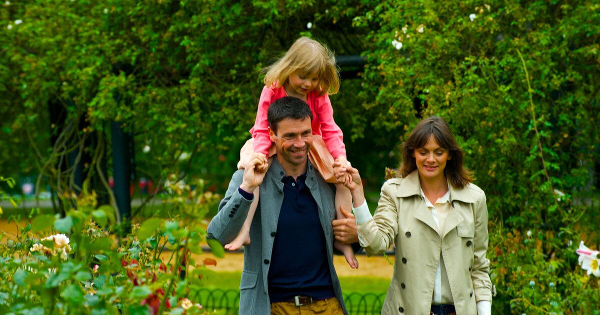 A family enjoying a walk in a park.