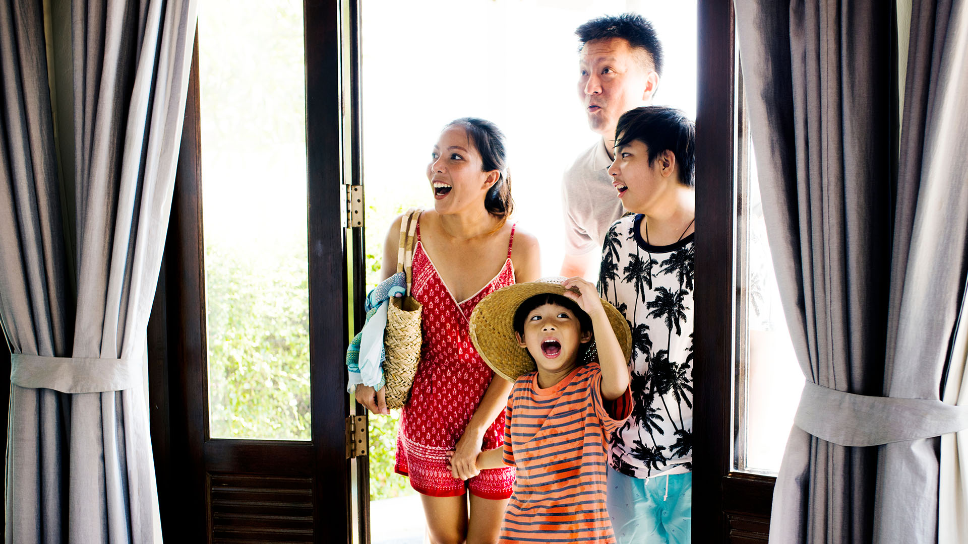 family entering hotel room 