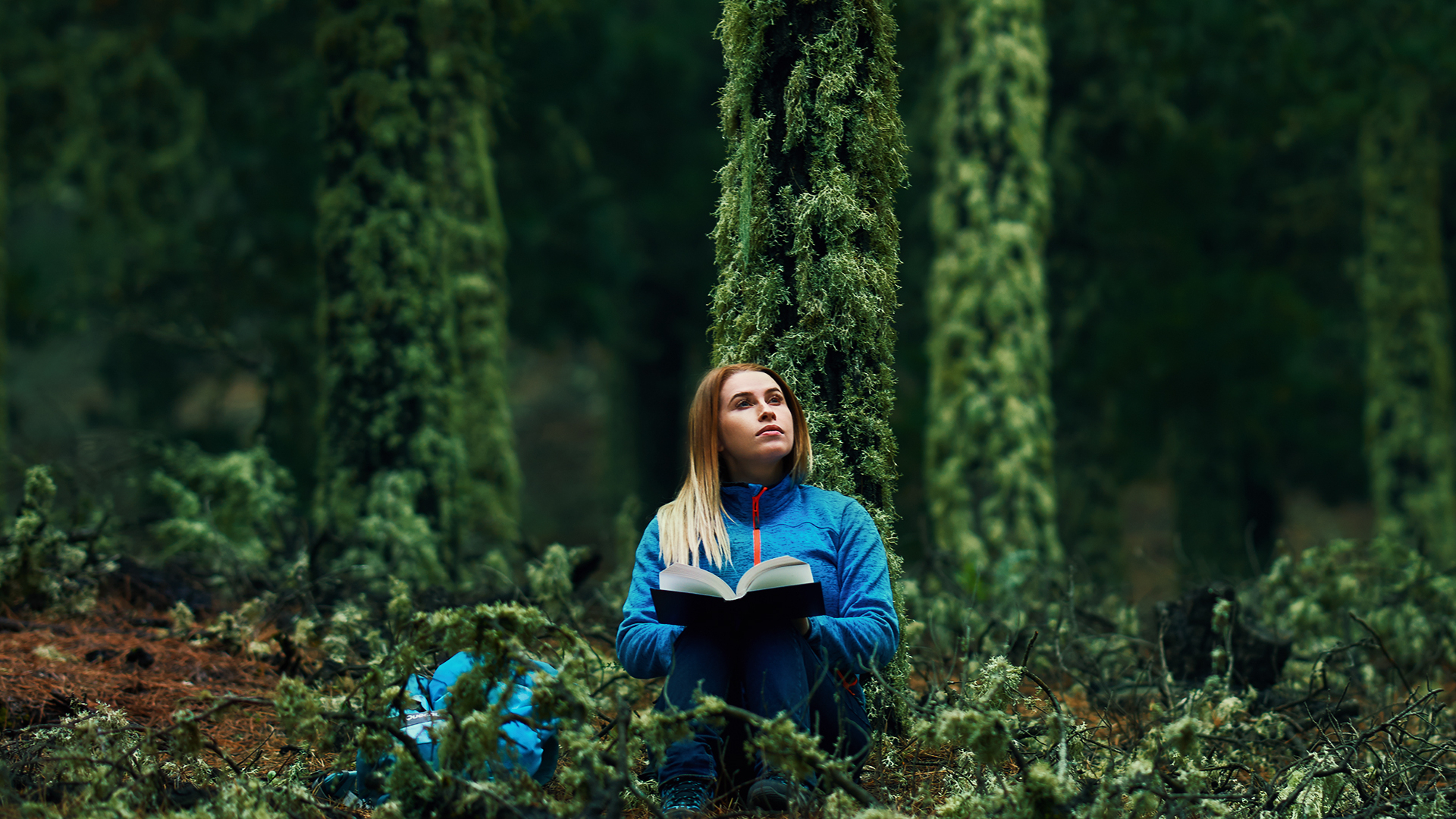 women readingin forest