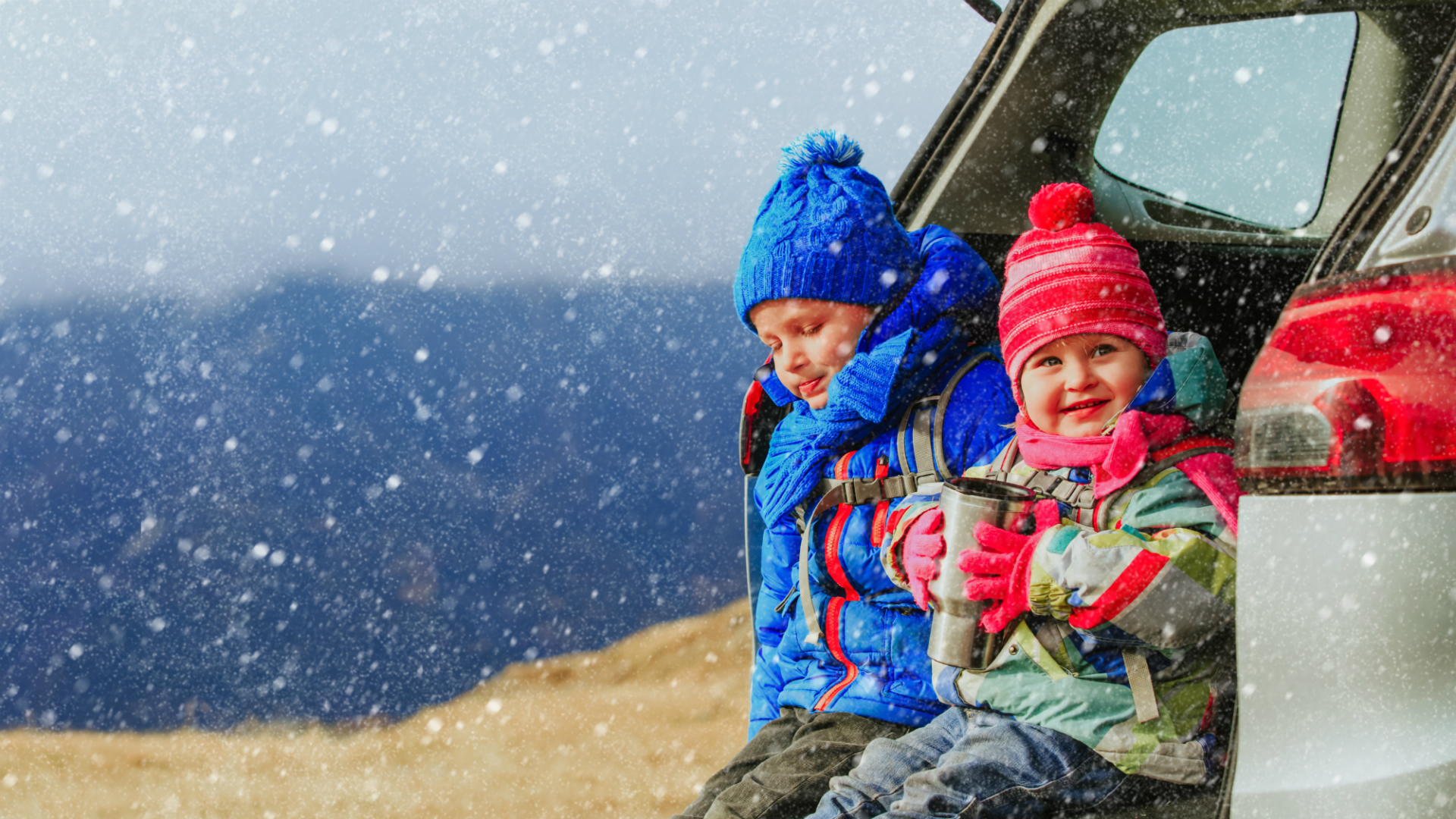 kids in back of car hatchback in snow bundled up winter 