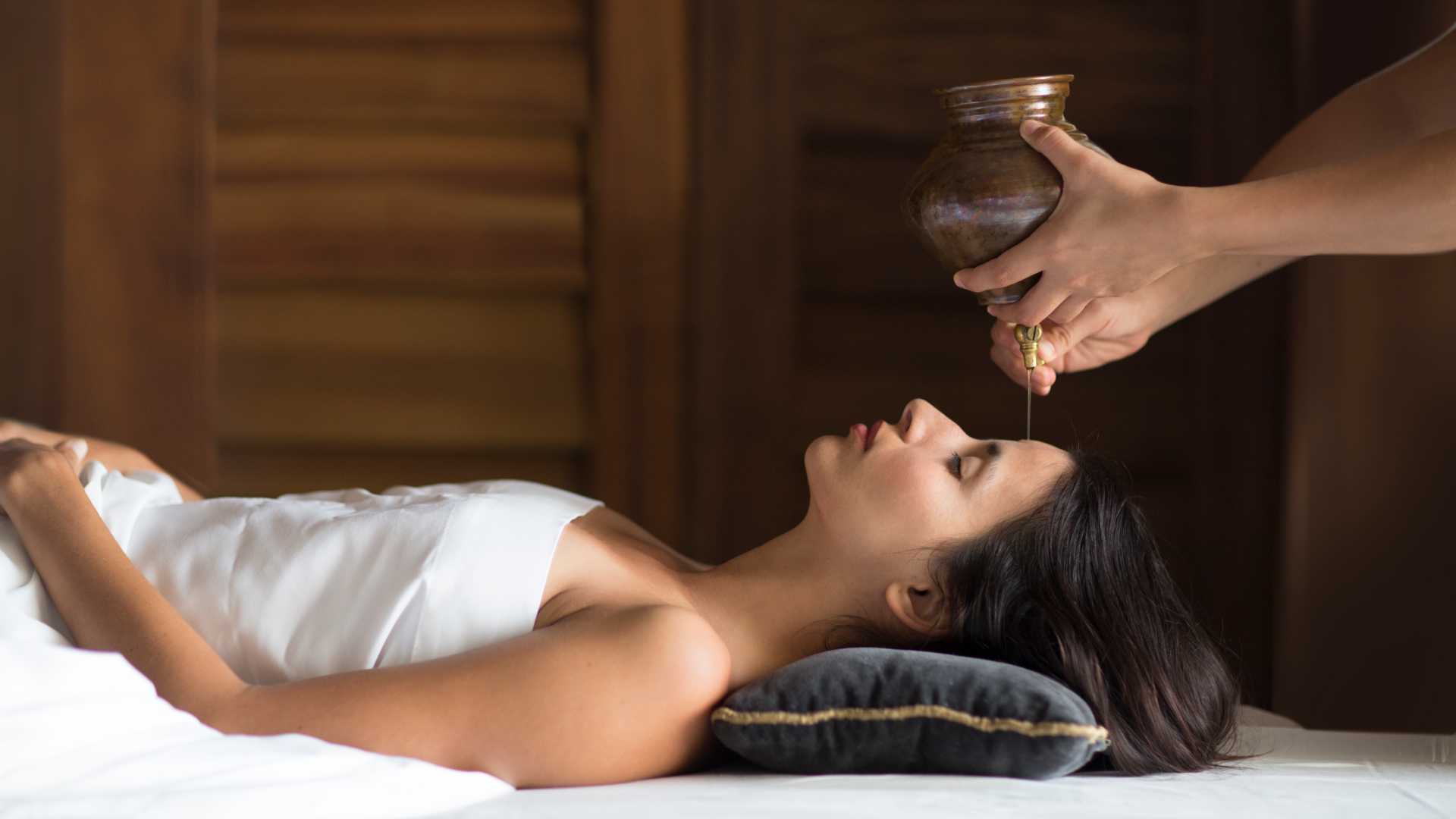 woman receiving oil massage in spa