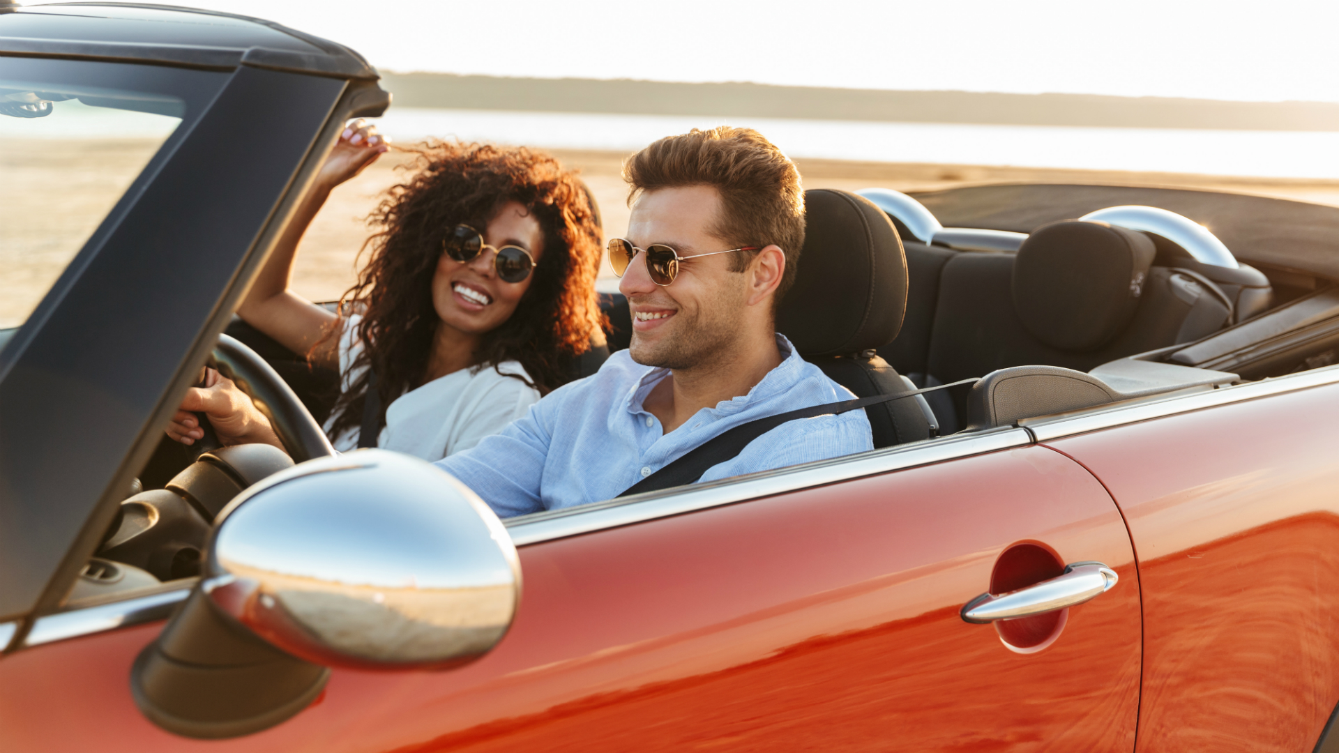 couple road tripping in convertible car