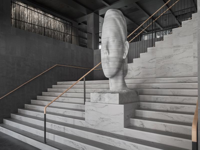 Lobby entrance with sculpture at At Six 