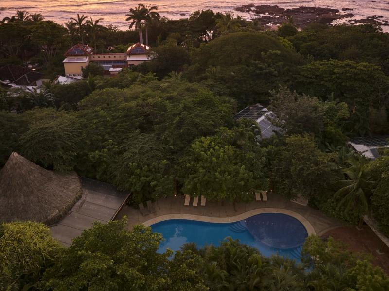 Aerial View of Pool and Hotel with Ocean in the Background