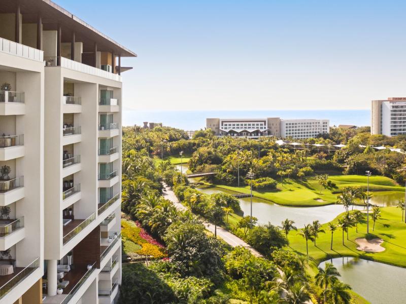 Facade View with Guestroom or Suite Balconies and Golf Course in the Background