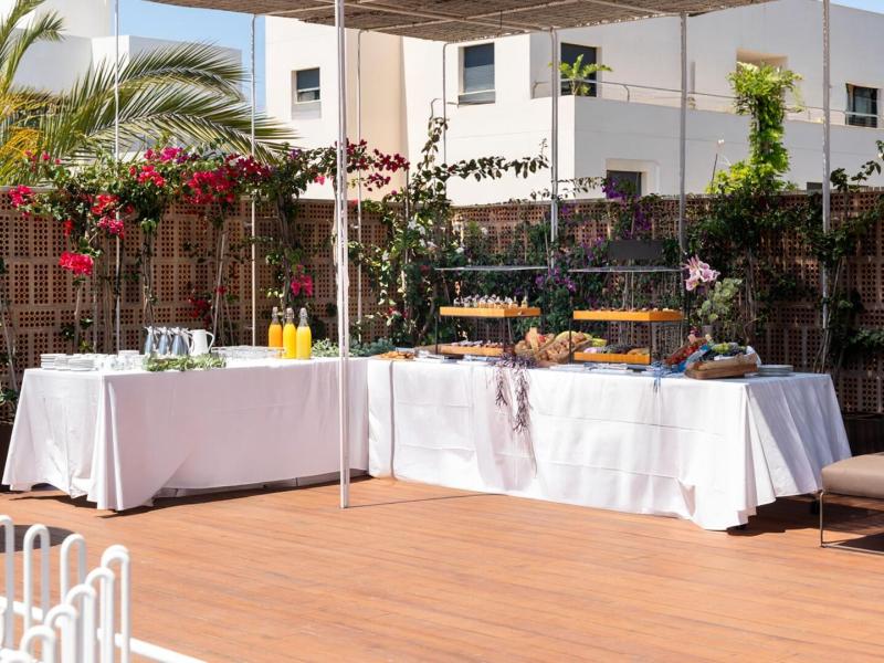 Guests will be delighted with a beautifully arranged buffet in a serene outdoor setting accented by blooming flowers and natural charm.