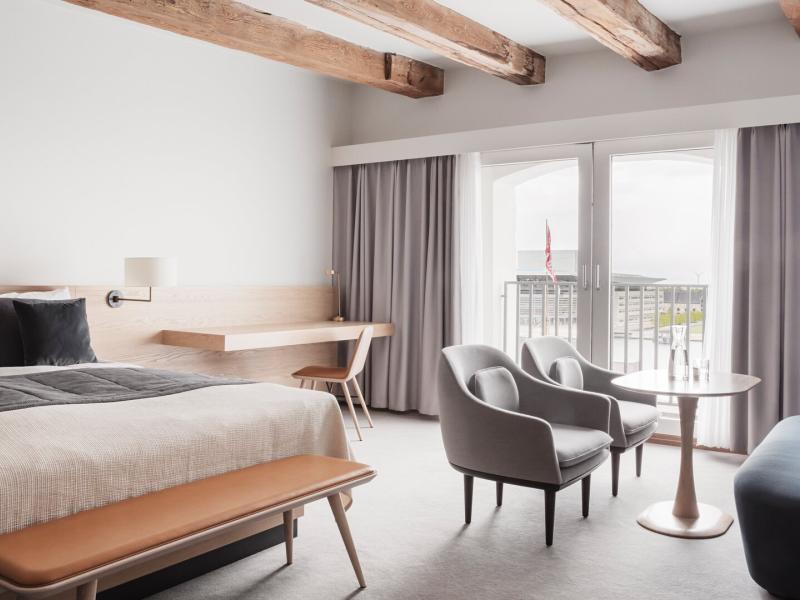 Spacious suite showcasing Scandinavian design, custom furnishings, and views over Copenhagen Harbor for an elevated stay experience.