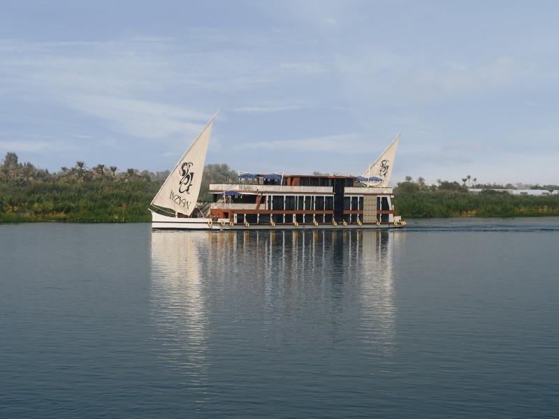 Mazaj Meroot double-deck sailing vessel adorned with artisanal woodwork, sweeping glass panels, and majestic traditional sails for an unparalleled luxury experience.