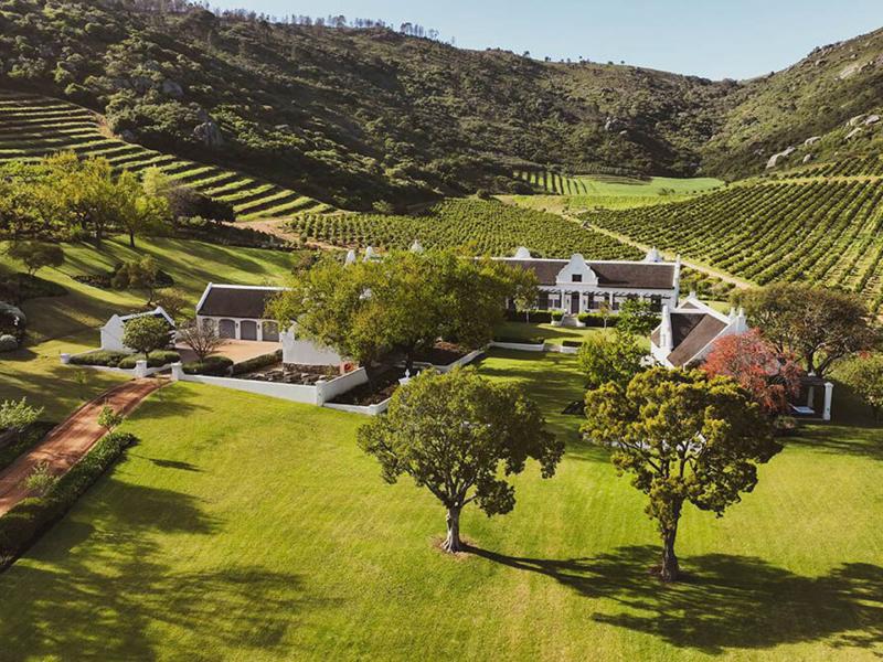 Luxurious countryside estate, Owloon Manor House is surrounded by rolling vineyards, manicured lawns, and majestic mountain views.