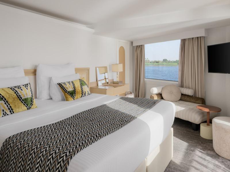 Royal Suite bedroom features modern elegance and ultimate comfort with sleek contemporary design, soft neutral tones, and panoramic river views for a serene escape.