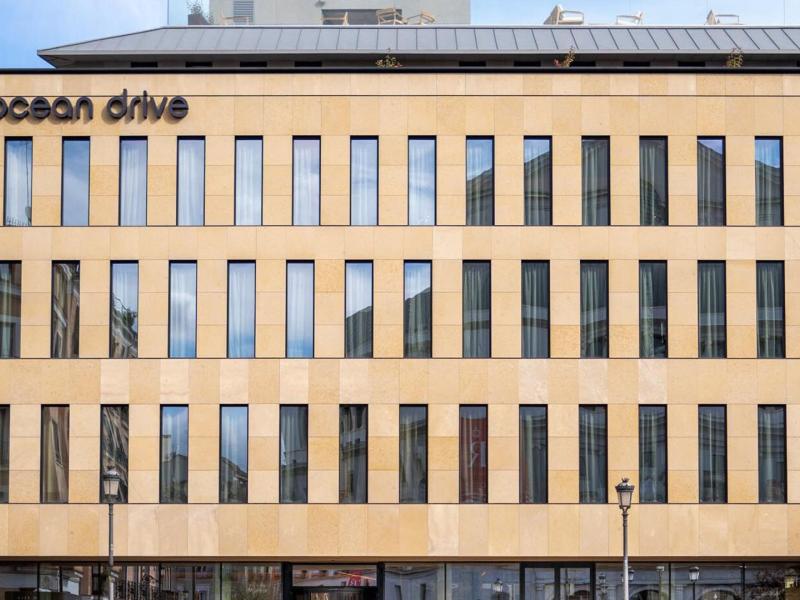 Showcasing a sleek modern façade, Ocean Drive Madrid stands out with its clean lines and contemporary design.