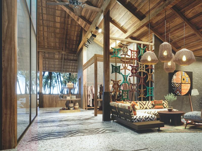 ENVI Paje inviting lobby with soaring wooden ceilings and patterned tile flooring, accented by earthy tones and colorful geometric décor for a warm tropical ambiance.