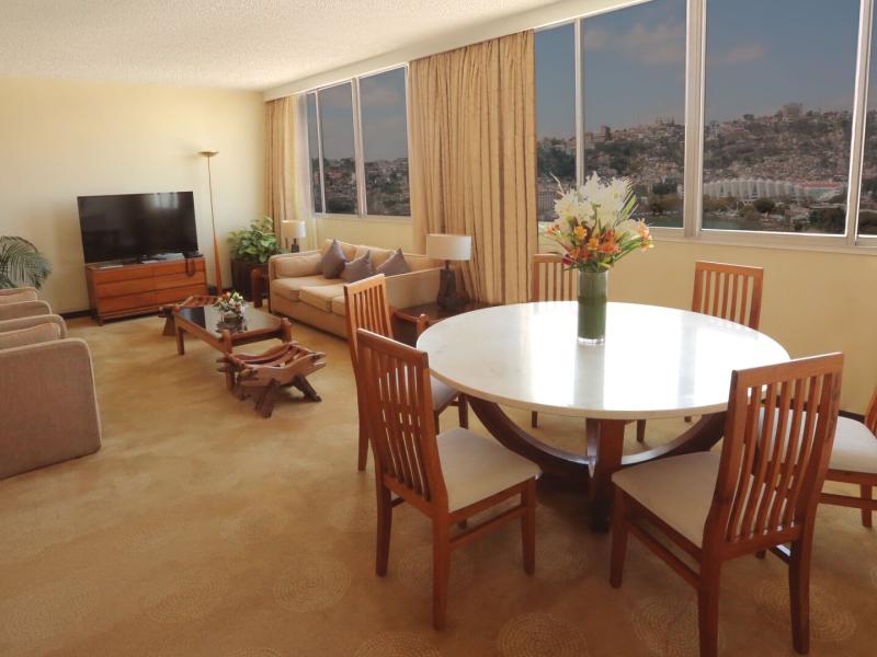 Presidential Suite offers a stylish dining area and inviting living space with natural wood accents and calming cream hues.