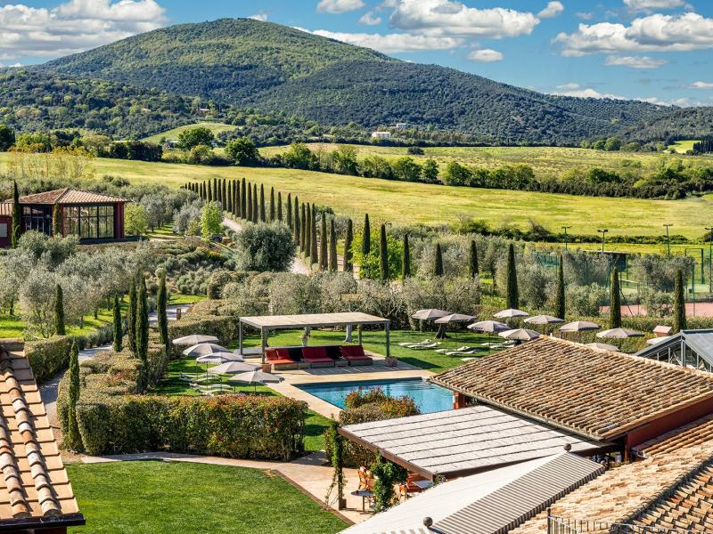 Rolling hills frame a serene property of Locanda Rossa featuring cypress-lined paths, tiled rooftops, and a sparkling pool, complemented by rich greens, earthy browns, and soft sky blues.