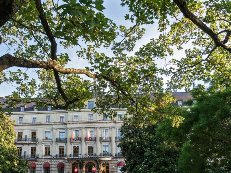 The historic façade of Hôtel Métropole Genève, ideally located on the Rive Gauche facing the Jardin Anglais and Lake Geneva.