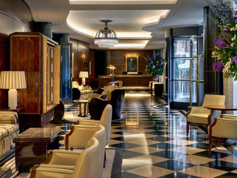 A striking Art Deco arrival, where geometric lines, polished surfaces, and curated artworks set the tone for a refined Mayfair escape.