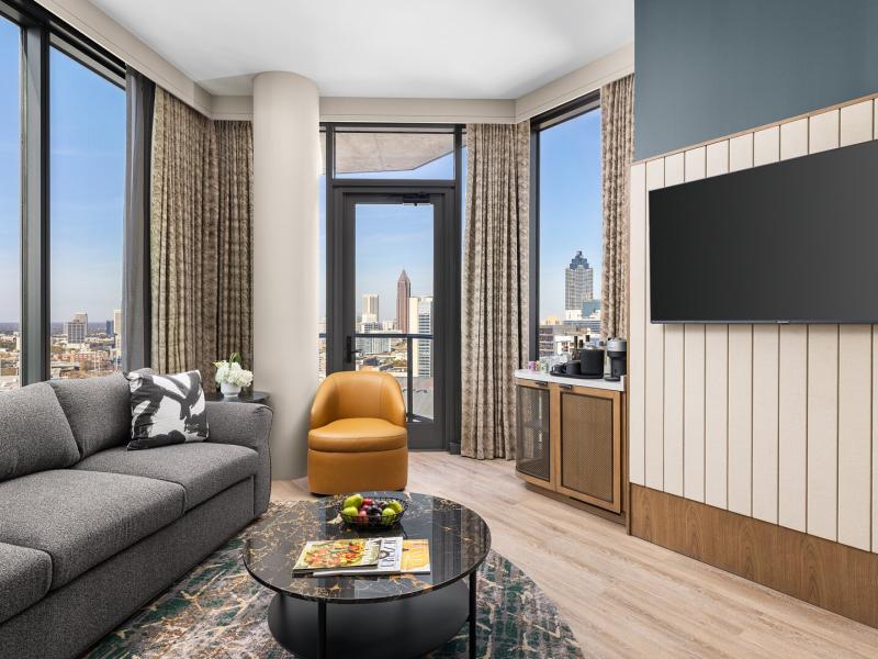 Residential-style suite accommodations feature expansive city views and elevated comforts for VIP attendees and executive stays.