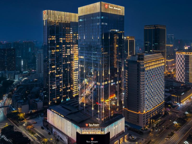 Rising above the city skyline, Tonino Lamborghini Hotel Chengdu striking glass tower dazzles with shimmering gold accents and deep midnight-blue tones in the heart of Chengdu.