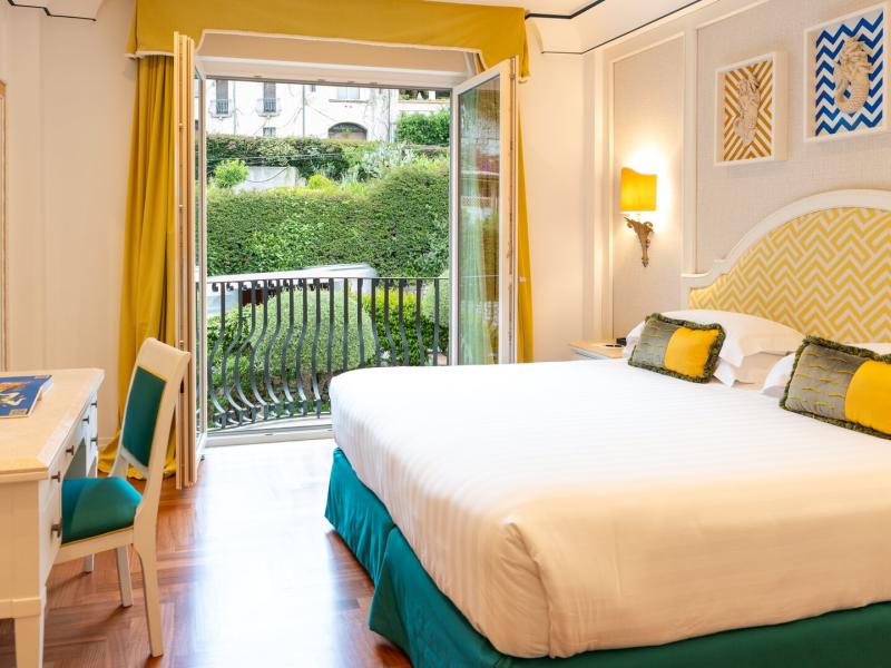 Comfortable guest accommodations with a private balcony, providing a relaxing retreat between meetings and events.