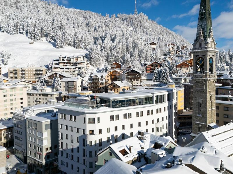 Set in the heart of snow-draped St. Moritz, art boutique Hotel Monopol white architecture is paired with sweeping alpine vistas, sapphire skies, frosted forests, and the iconic stone clock tower.