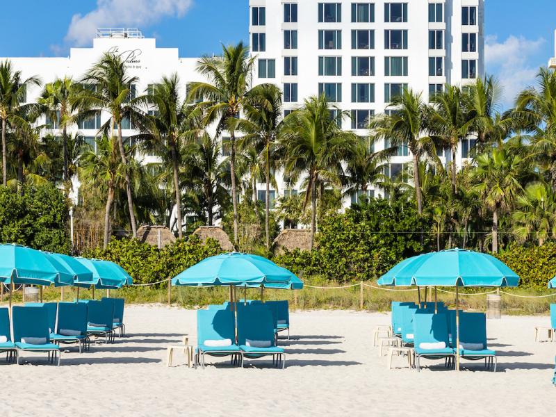 The Palms Hotel Beach with Chairs, Umbrellas, and Cabanas