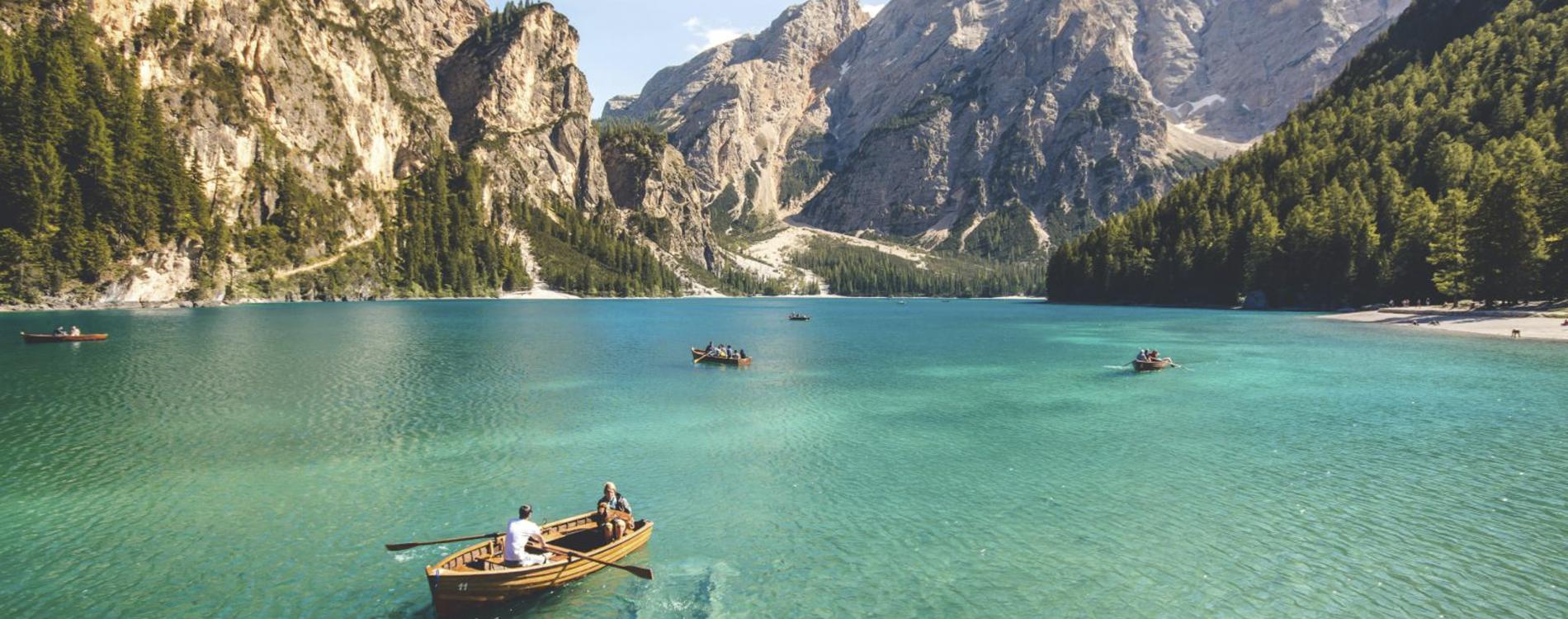 Preferred Hotels & Resorts I Prefer Planner - Contract with Confidence | Boat in water with mountains in background