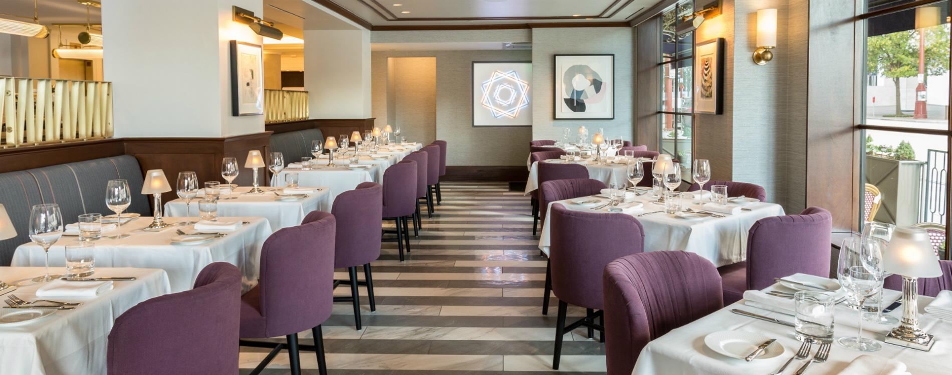 a restaurant dining room with tables set for dinner