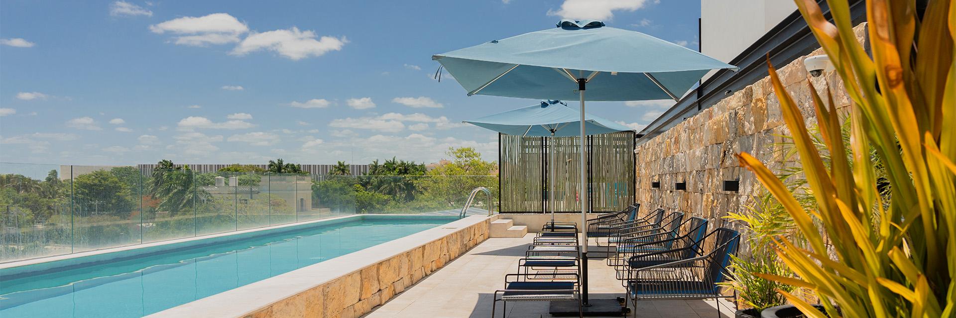 Las Brisas Merida Pool with Loungers and Umbrellas
