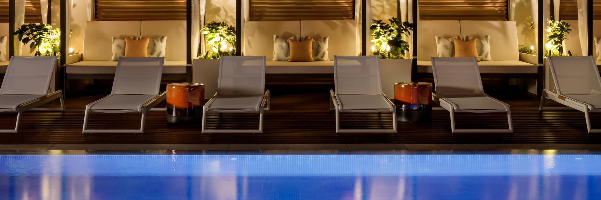 Halepuna Waikiki by Halekulani Pool and Cabanas at Night