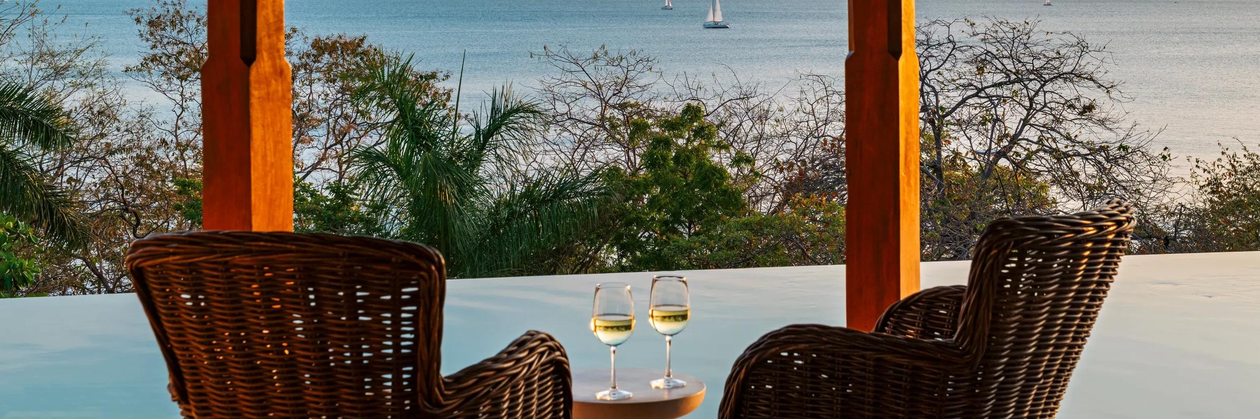 Santarena Hotel | Rooftop Pool Seating with Drinks and Ocean in the Background