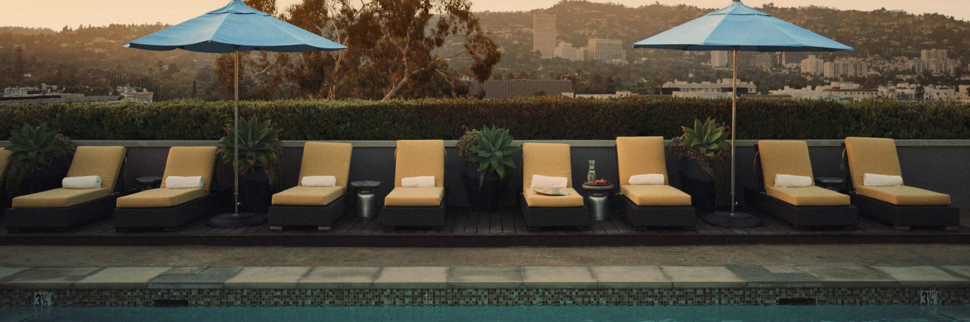 L'ermitage Beverly Hills Outdoor Swimming Pool with Umbrellas and Loungers
