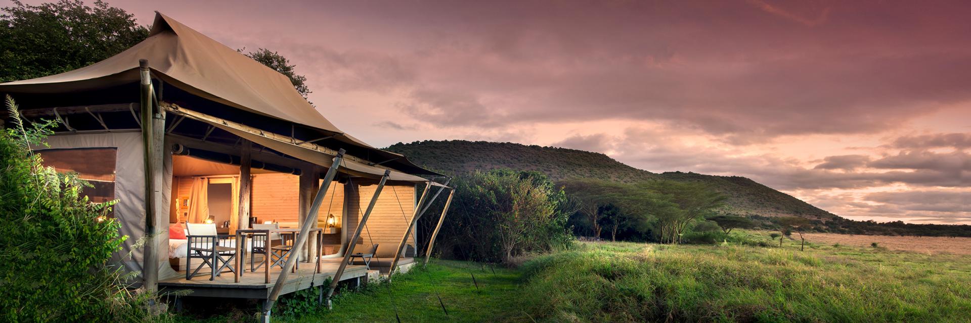 andBeyond Kichwa Tembo Tented Camp Exterior of Tented Accommodations at Dusk